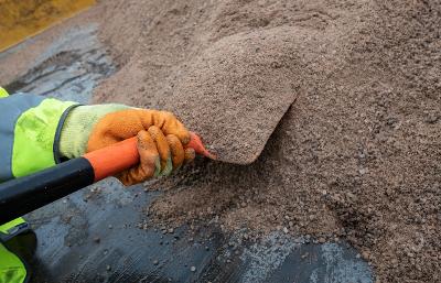 Grit team worker shoveling grit