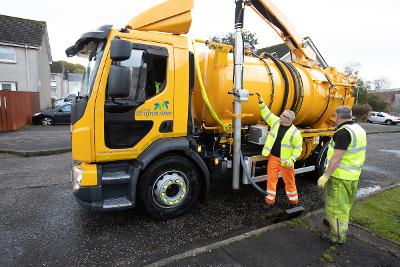 Roads workers unblocking drain Roads workers unblocking drain
