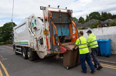 Refuse collectors loading brown bins Refuse collectors loading brown bins