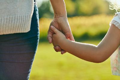 Parent holding child's hand Parent holding child's hand