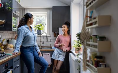 Mum and teenager Women and teenage girl in kitchen